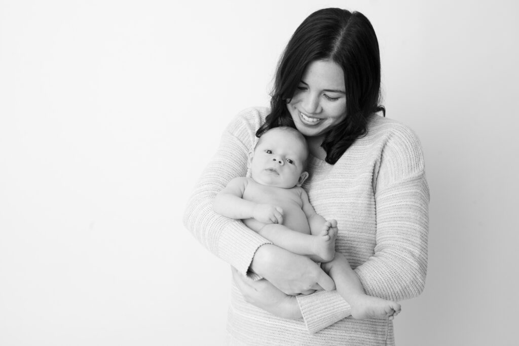 Newborn and mother in classic newborn picture in black and white at photo studio in Portland Oregon